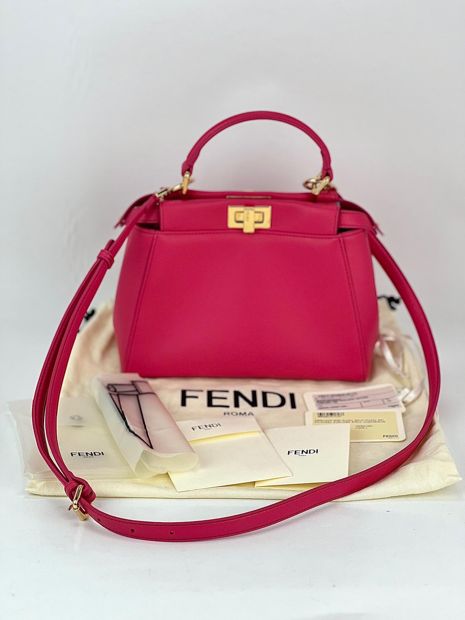 Pre-Owned  100% Authentic
Fendi Mini Peekaboo Pink Leather Hand Shoulder Bag
RATING: A/B...Very Good, well maintained, 
shows minor signs of wear
MATERIAL: soft smooth lambskin leather
STRAP: Fendi removable adjustable strap 39'' to 46'' long
DROP: