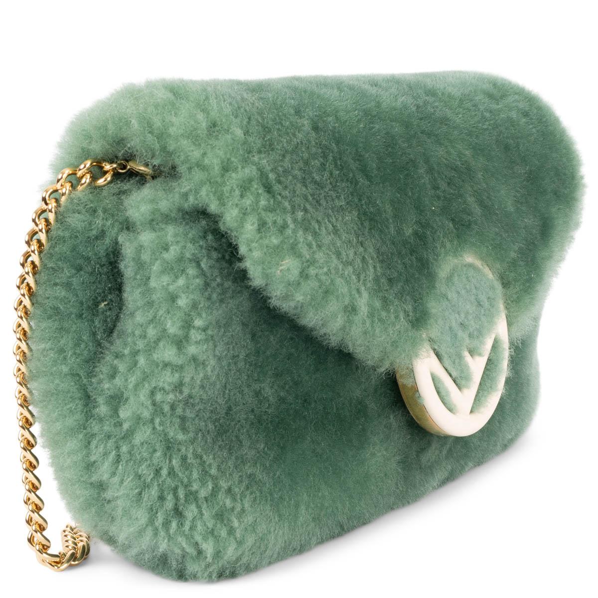 100% authentic Fendi logo belt & crossbody bag in mint green shearling. The design features a detachable gold-tone metal chain link shoulder-strap and a detachable leather belt bag strap. Lined in mint green canvas with two leather credit card