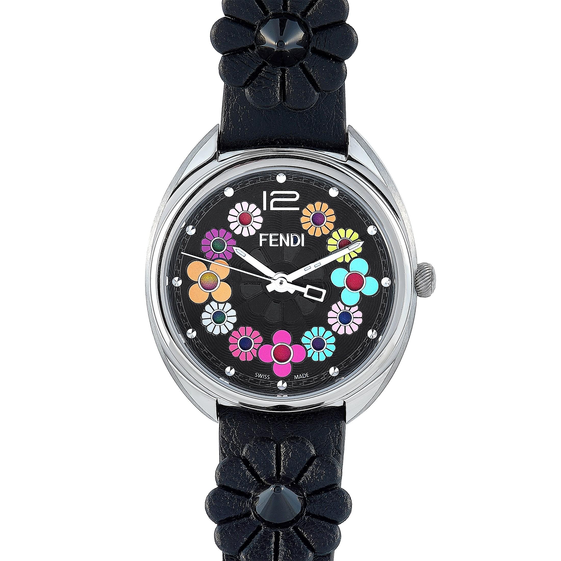 This is the Fendi Momento watch, reference number F234031011.

It is presented with a 34 mm stainless steel case that offers water resistance of 100 meters. The watch is worn on a black leather strap fitted with a tang buckle. The black dial is