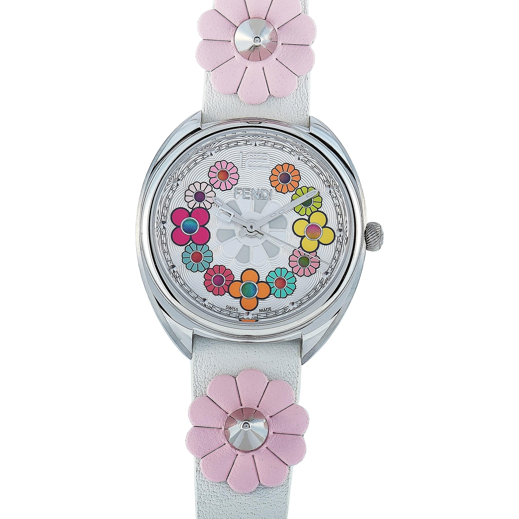 This is the Fendi Momento watch, reference number F234034041.

It is presented with a 34 mm stainless steel case that offers water resistance of 100 meters. The watch is worn on a white leather strap decorated with pink flowers and fitted with a