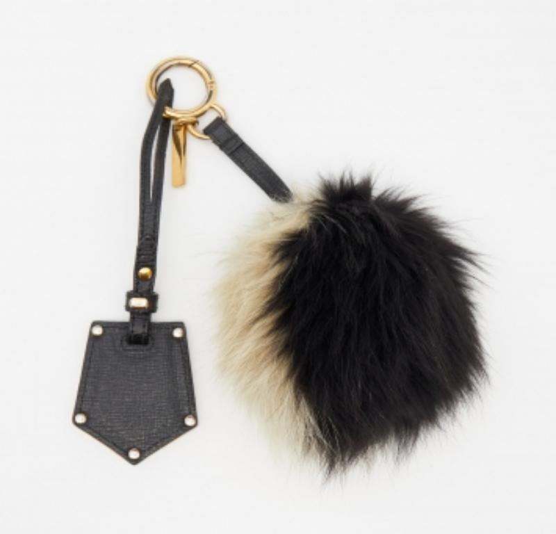 Fendi brings you this quirky bag charm that has caught the eye of handbag lovers around the world. The charm consists of a monster bug with eye detailing, fur all over, and is held by a leather strap with a gold-tone clasp. Adorn your precious bags