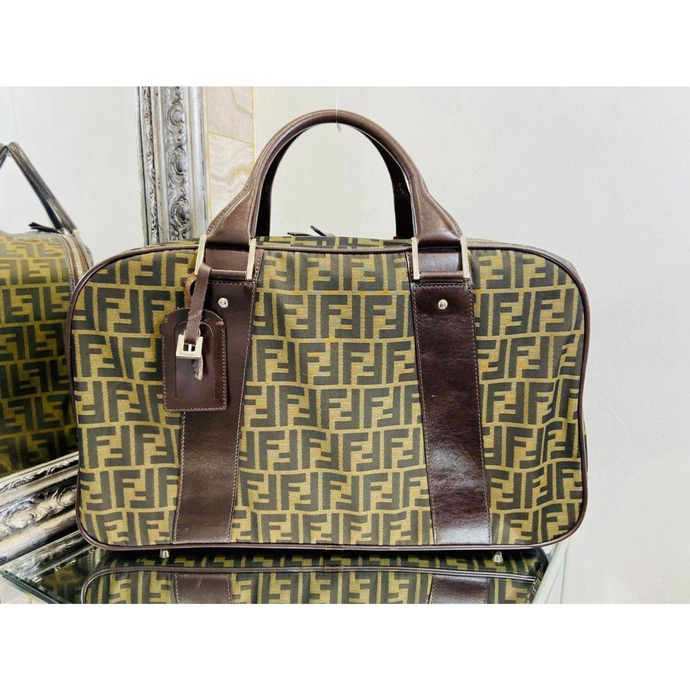 Fendi Monogram Travel Bag

Canvas logo printed bag with dark chocolate brown leather trim and carry handles. Logo engraved silver Hardware. Leather luggage tag. Zipper closure.
Stud feet to the base.

Additional information:
Size: 51 W x 15 D x 30 H