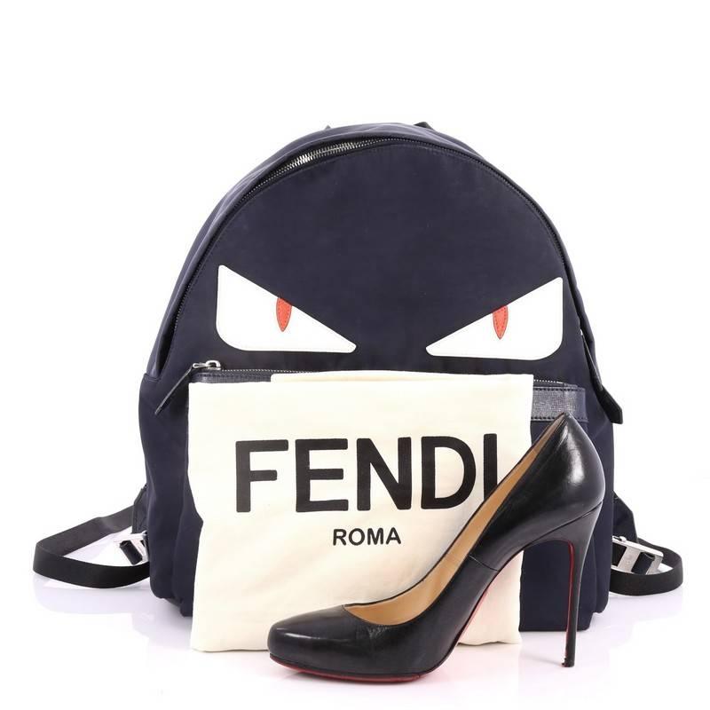 This authentic Fendi Monster Backpack Nylon Large balances a luxurious, playful style made for on-the-go fashionistas. Crafted from navy nylon, this backpack features white monster eye applique design, a flat top handle, padded adjustable shoulder