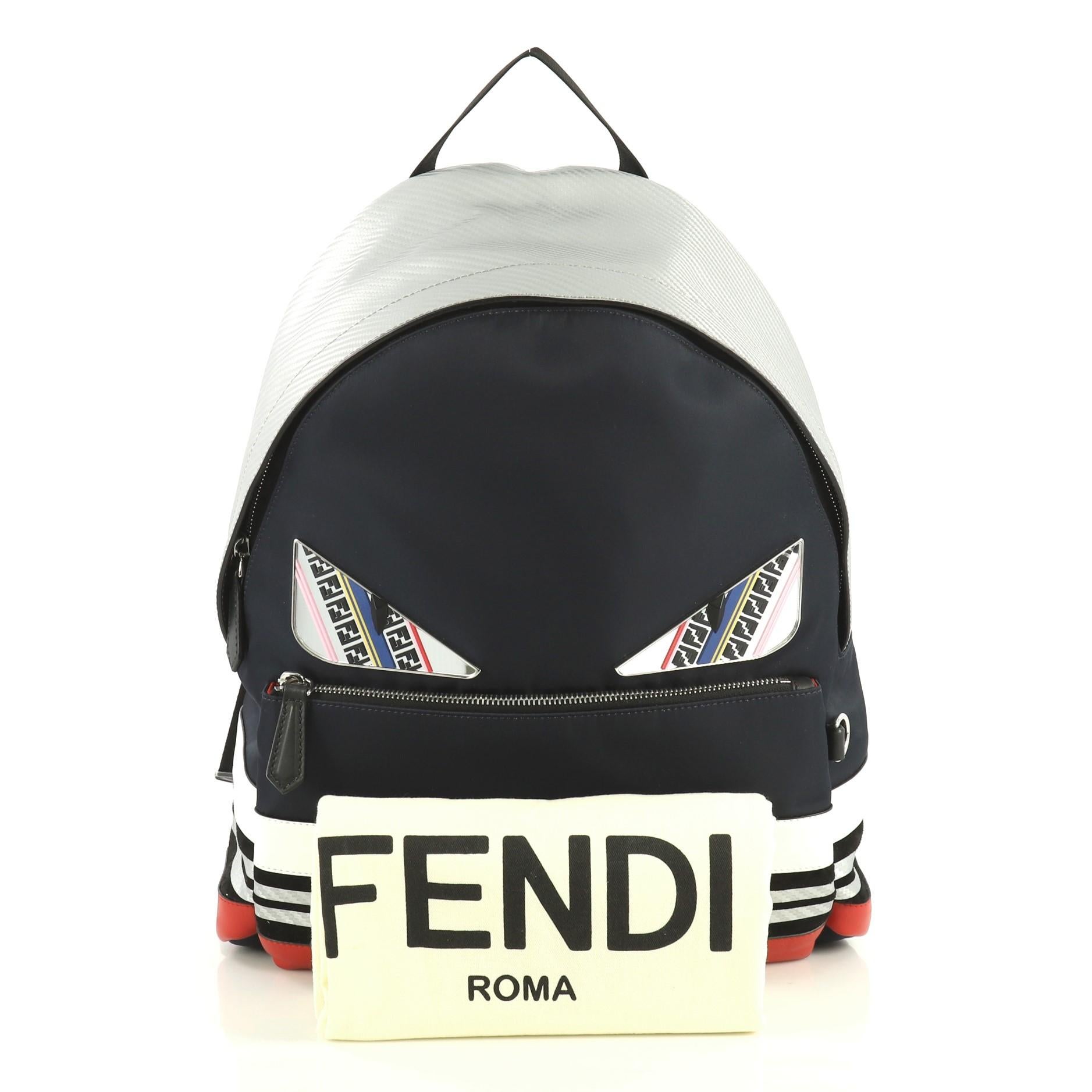 This Fendi Monster Backpack Nylon with Leather Large, crafted from blue nylon and multicolor leather, features adjustable shoulder straps, monster design, exterior front zip pocket, and silver-tone hardware. Its zip closure opens to a black nylon
