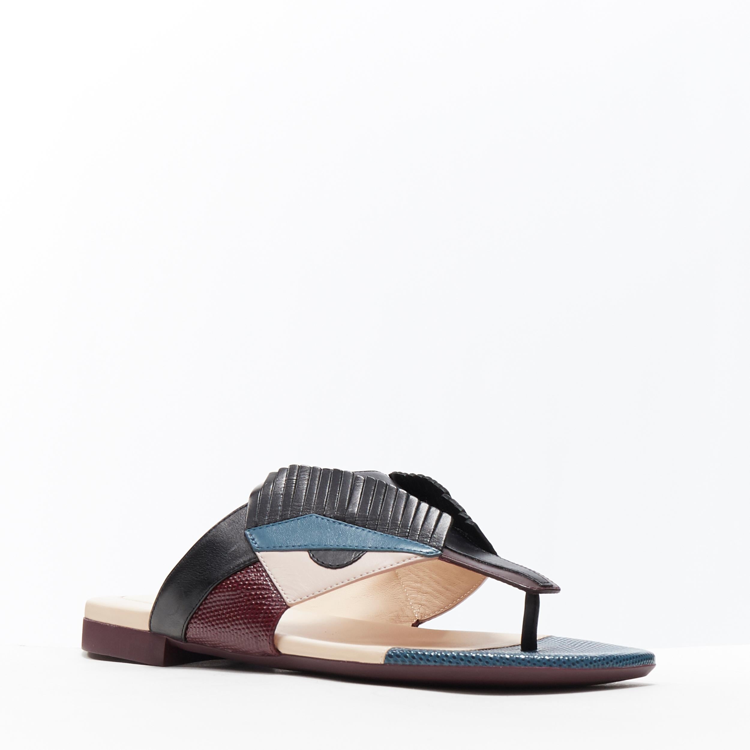 FENDI Monster Bug Eye angry eyelash face colorblocked flat thong slippers EU35
Brand: Fendi
Model Name / Style: Monster sandals
Material: Leather
Color: Black, purple, navy
Pattern: Geometric
Extra Detail: Thong sandals. Flat (Under 1 in) heel