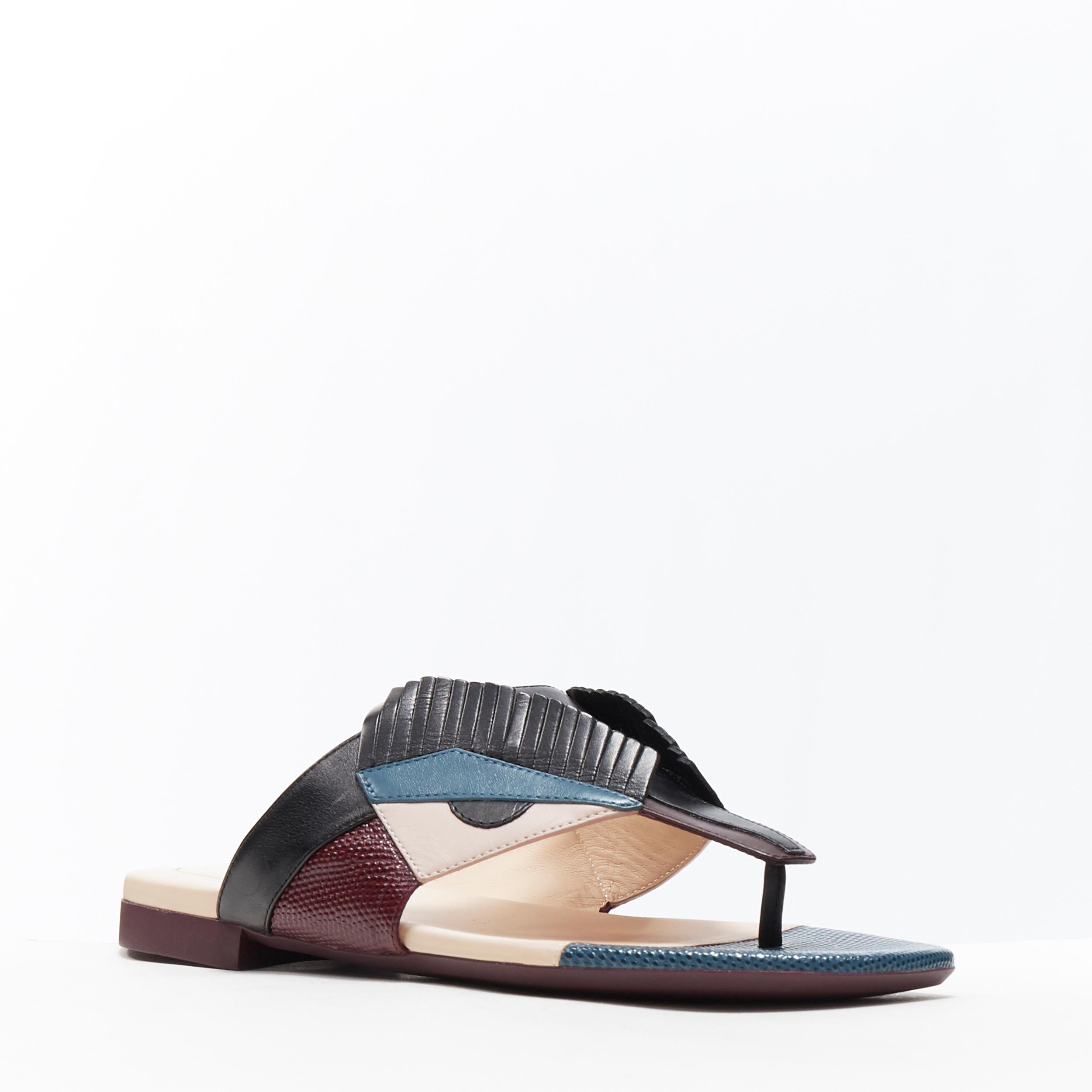 Chanclas planas FENDI Monster Bug Eye cara de pestaña enfadada EU35
Marca: Fendi
Nombre del modelo / Estilo: Sandalias Monster
Material: Piel
Color: Negro, morado, azul marino
Patrón: Geométrico
Detalle extra: Sandalias tanga. Altura de tacón plana