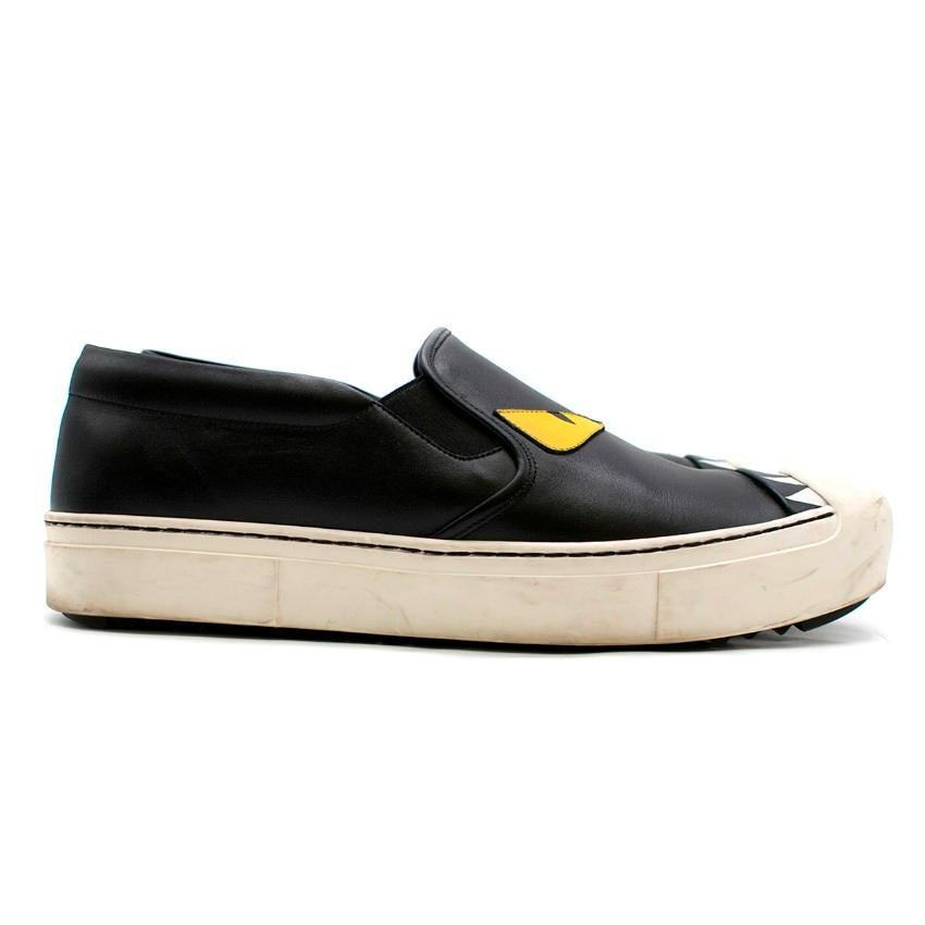 Fendi Monster Eyes Leather Loafers

- Black leather loafers
- Slip-on style
- Monster face vamp, with yellow eyes and white teeth
- Rounded white rubber toe cap
- Black leather lining with logo embroidered
- Pyramid-stud rubber outsole
- Logo on the