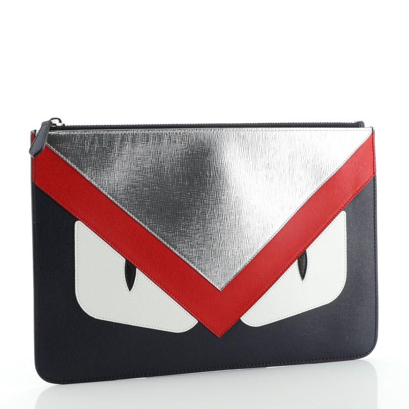 Condition: Excellent. Minimal wear on exterior, scratches on hardware. 
Accessories: No Accessories 
Measurements: 
Designer: Fendi
Model: Monster Pouch Leather Medium
Exterior Material: Leather 
Exterior Color: Blue, Red, Silver 
Interior Material: