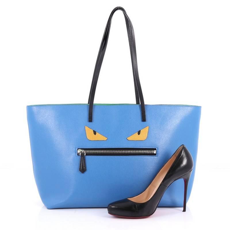 This authentic Fendi Monster Roll Tote Leather Medium is a uniquely, kitschy tote perfect for everyday looks. Crafted from blue leather, this eye-catching lightweight tote features dual slim leather straps, front zip pocket designed as the monster's