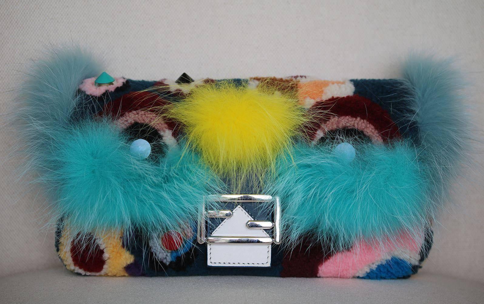 Genuine fox fur and lambskin leather form the fabulously fierce Monster face on this signature shoulder bag from Fendi. Made from colorful shearling in collection-defining flower motifs, this compact style is trimmed with cone studs and finished