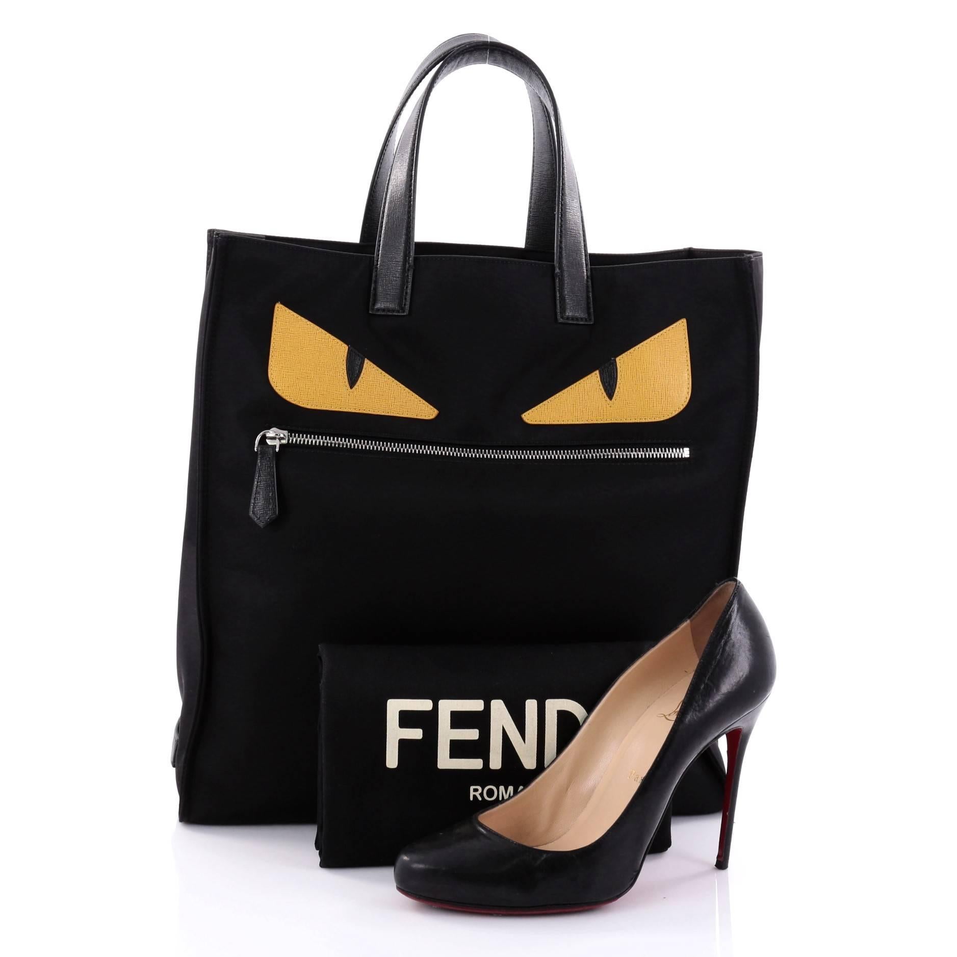 This authentic Fendi Monster Tote Nylon is a stylishly bold, modern tote perfect for any on-the-go moments. Crafted from black nylon, this easy-to-carry tote features dual flat black leather handles, eye-catching yellow monster eye applique design,