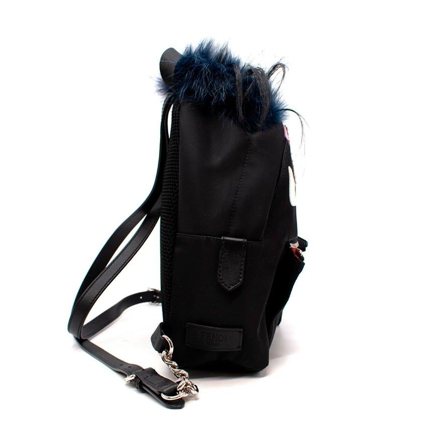  Fendi Monsters Fox-Fur Trim Twill Backpack
 

 - Small backpack with playful monster face applique topped with a dyed fox fur pom pom
 - Leather appliques on a canvas twill base
 - Adjustable leather straps
 

 

 Made in Italy
 Dyed fur from New