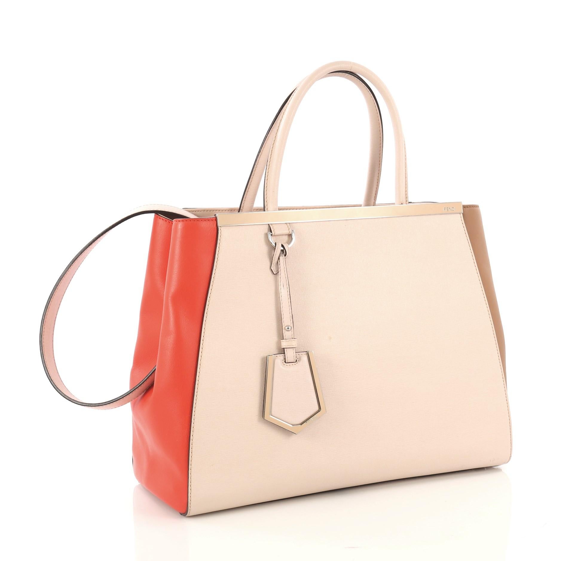 This Fendi Multicolor 2Jours Bag Leather Medium, crafted from red, pink and brown leather, features dual rolled leather handles, top bar with Fendi brand name, protective base studs, and silver-tone hardware. Its magnetic snap tab closure opens to a