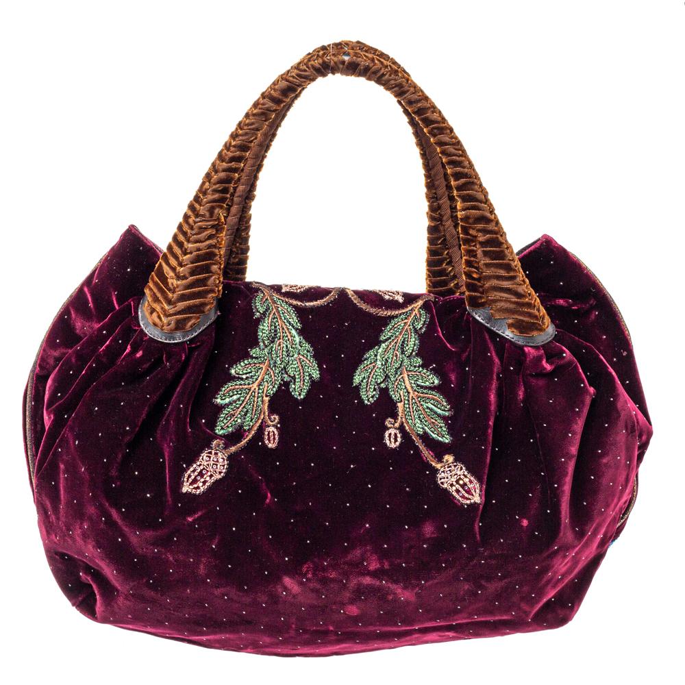 This chic Spy bag is from Fendi. The bag is crafted from plush velvet with luxurious embroidery and features two woven handles on top. The bag also comes with a satin interior that can fit all your daily essentials. Flaunt this beauty wherever you