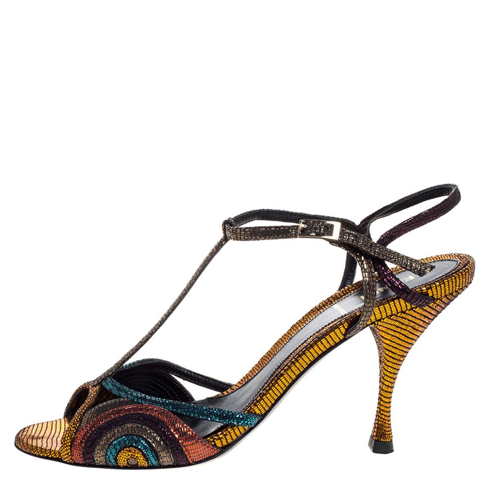 Glamorous, stylish, and striking, these Fendi sandals are absolute must-haves for a fashionista like you! Crafted in Italy, they are made from glitter leather and carry multicolored hues. They are styled with open toes, t-straps, buckled ankle