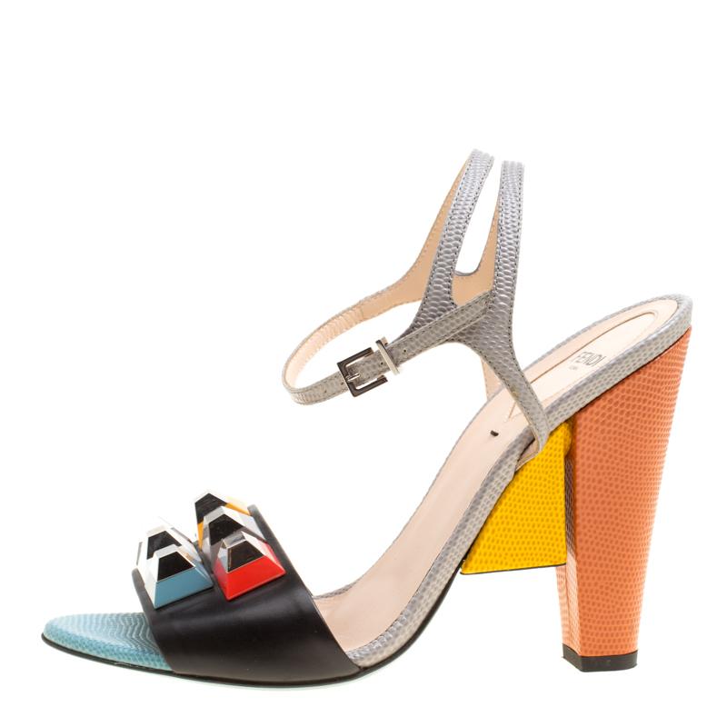 The broad frontal strap decked with rainbow studs makes this pair of sandals from Fendi a fun and quirky creation that looks just right for Sunday brunches and shopping sprees. Rendered in multicoloured leather, these sandals have high, block heels