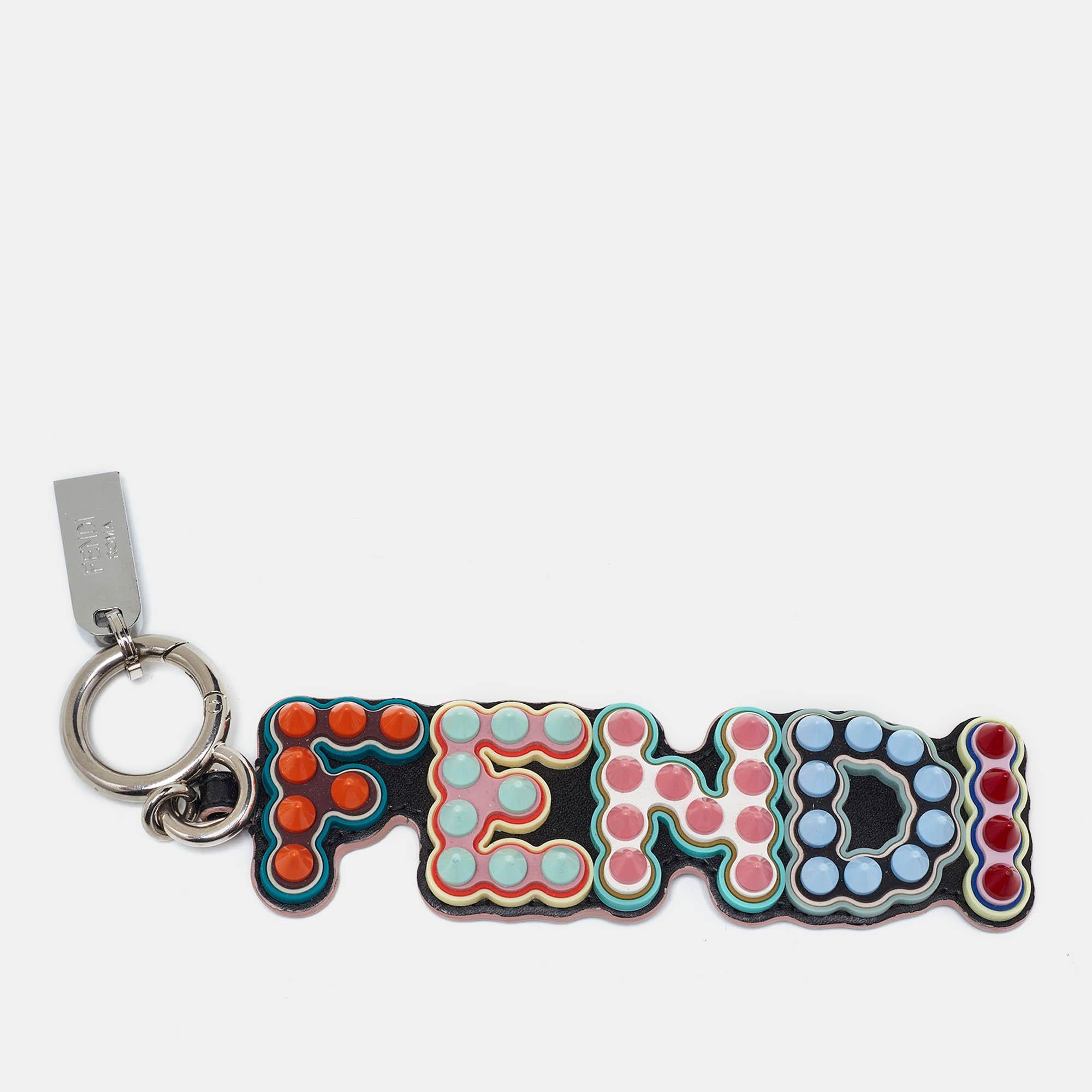 Fendis Logo Spike USB Key Chain pairs a silver tone metal key holder with a charm that spells FENDI. Colorful stud work makes it eye catching.