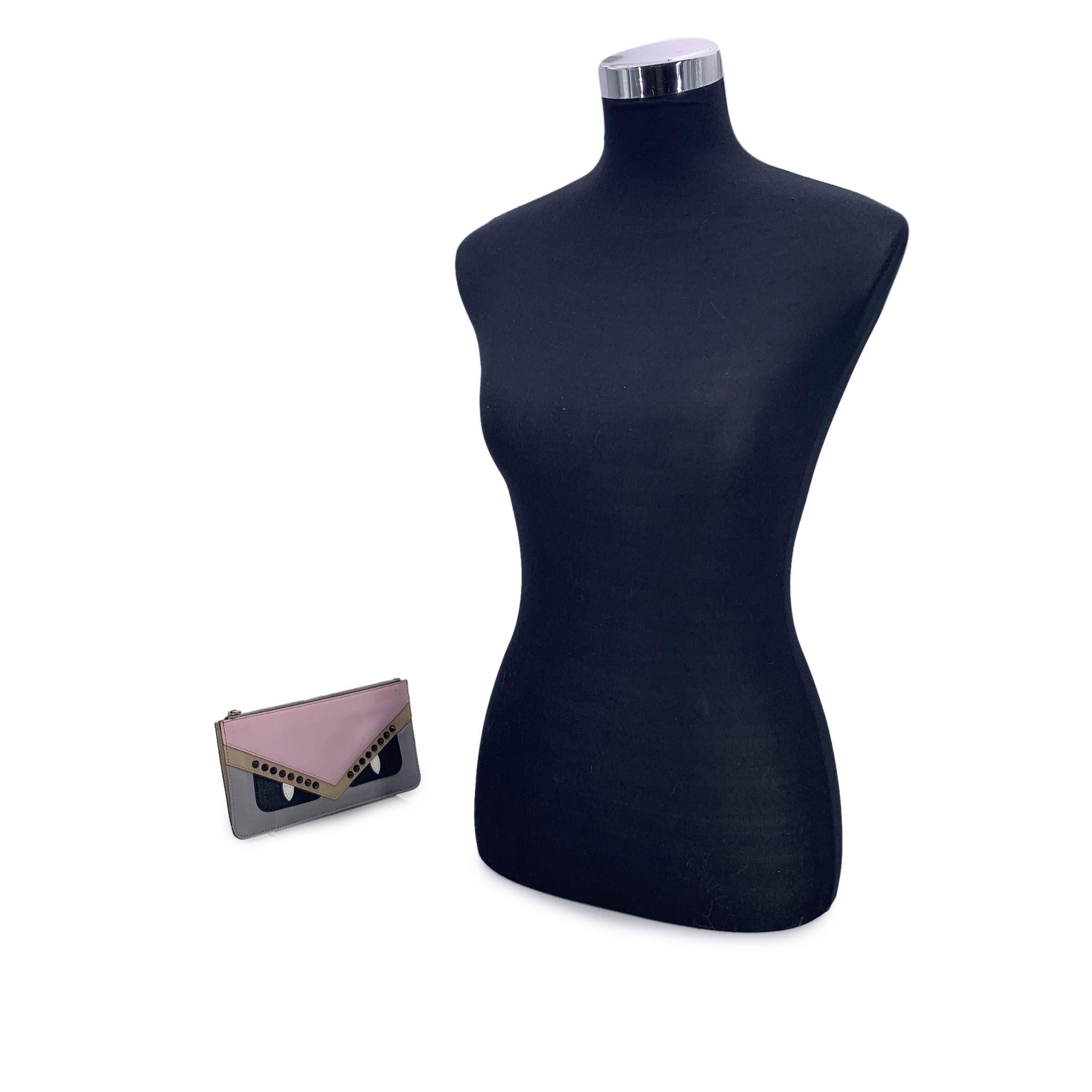 This beautiful item will come with a Certificate of Authenticity provided by Entrupy. The certificate will be provided at no further cost A rare and playful statement piece, this Fendi pochette 'Monster' Zip pouch is a striking blend of luxury and