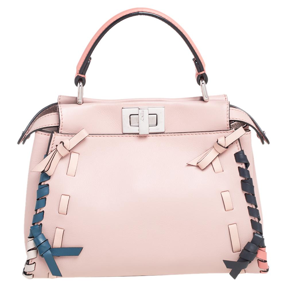 This exquisite Peekaboo from Fendi is highly coveted, and since its birth in 2009, it has swayed us with its shape, design, and beauty. This version comes meticulously crafted from leather and designed with a top handle for you to swing it. The