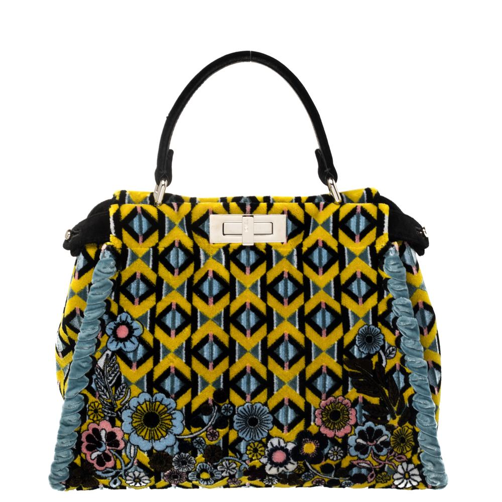 This exquisite Peekaboo from Fendi is highly coveted, and since its birth in 2009, it has swayed us with its shape, design, and beauty. This version comes meticulously crafted from printed velvet and designed with a top handle for you to swing it. A