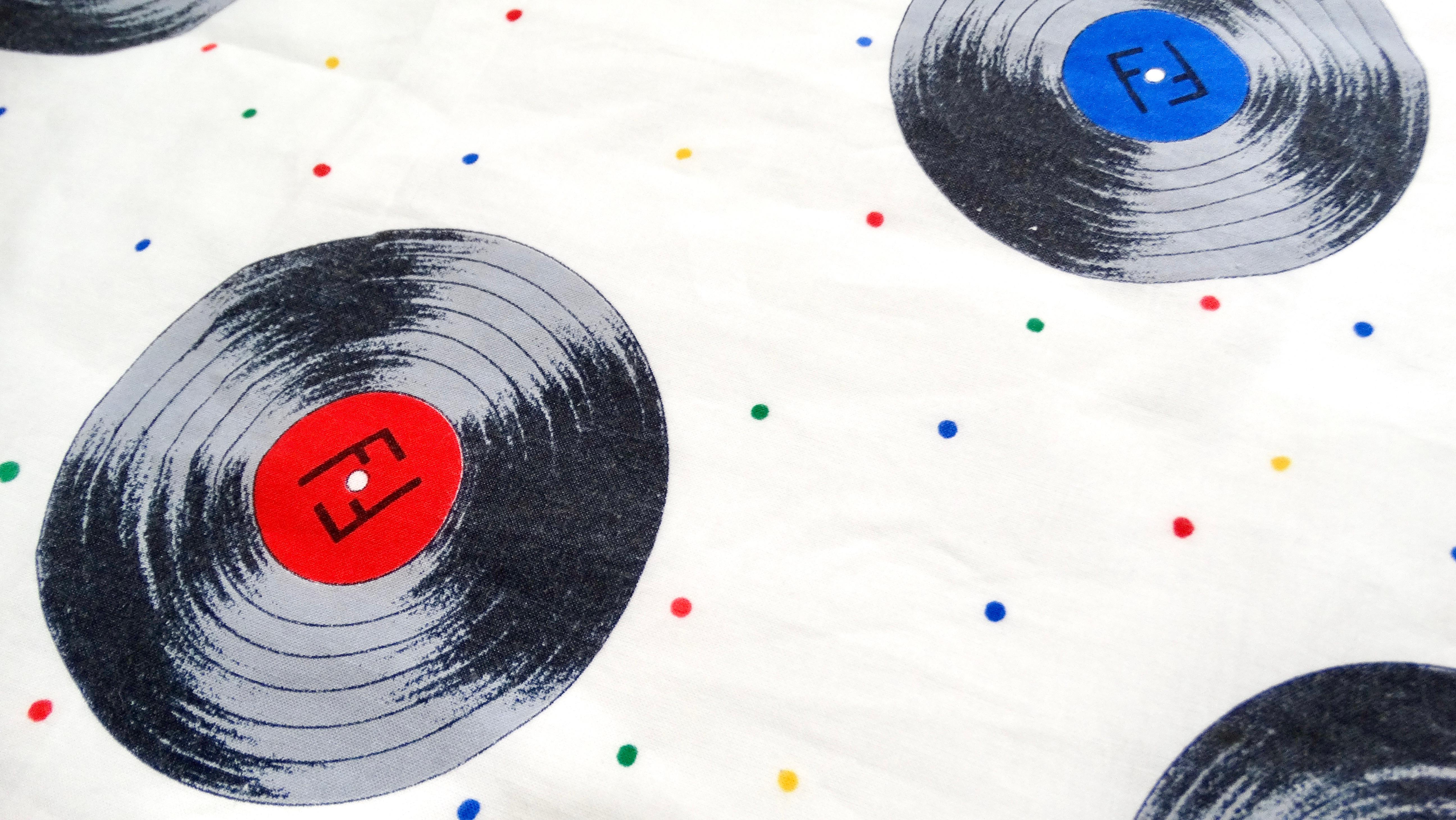 The Fendi Multicolor Record Print Cotton Scarf is a vibrant and luxurious accessory that effortlessly combines playful design with sophisticated craftsmanship. Featuring a lively array of multicolored record-inspired motifs, this scarf adds a pop of
