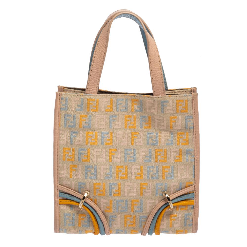 Complete a winning look with this Mini tote from Fendi. Crafted from colorful Zucchino canvas, the front comes with a striking F charm. The bag opens to a fabric-lined interior sure to fit in your everyday essentials. The dual handles and the