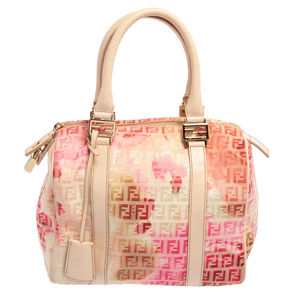 This elegant Forever Bauletto bag from Fendi is crafted from Zucchino canvas and is perfect for your fashionable outings. The beautiful bag features splendid details in the form of patent leather trims, dual top handles, and a padlock. The top zip