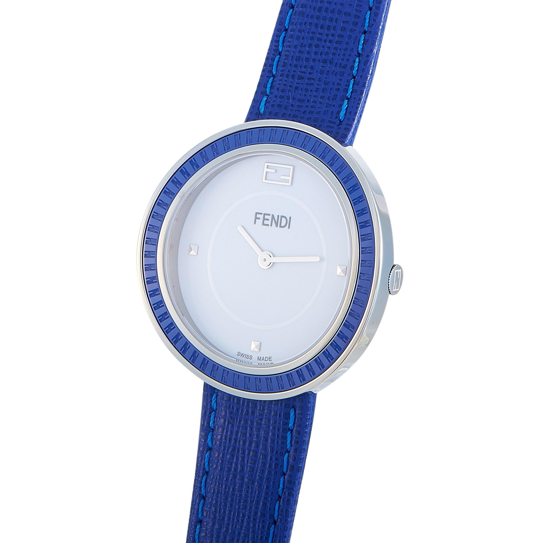 The Fendi My Way watch, reference number F356034031, boasts a 36 mm stainless steel case fitted with a blue ceramic bezel. The case is presented on a blue leather strap, secured on the wrist with a tang buckle. This model is powered by a quartz