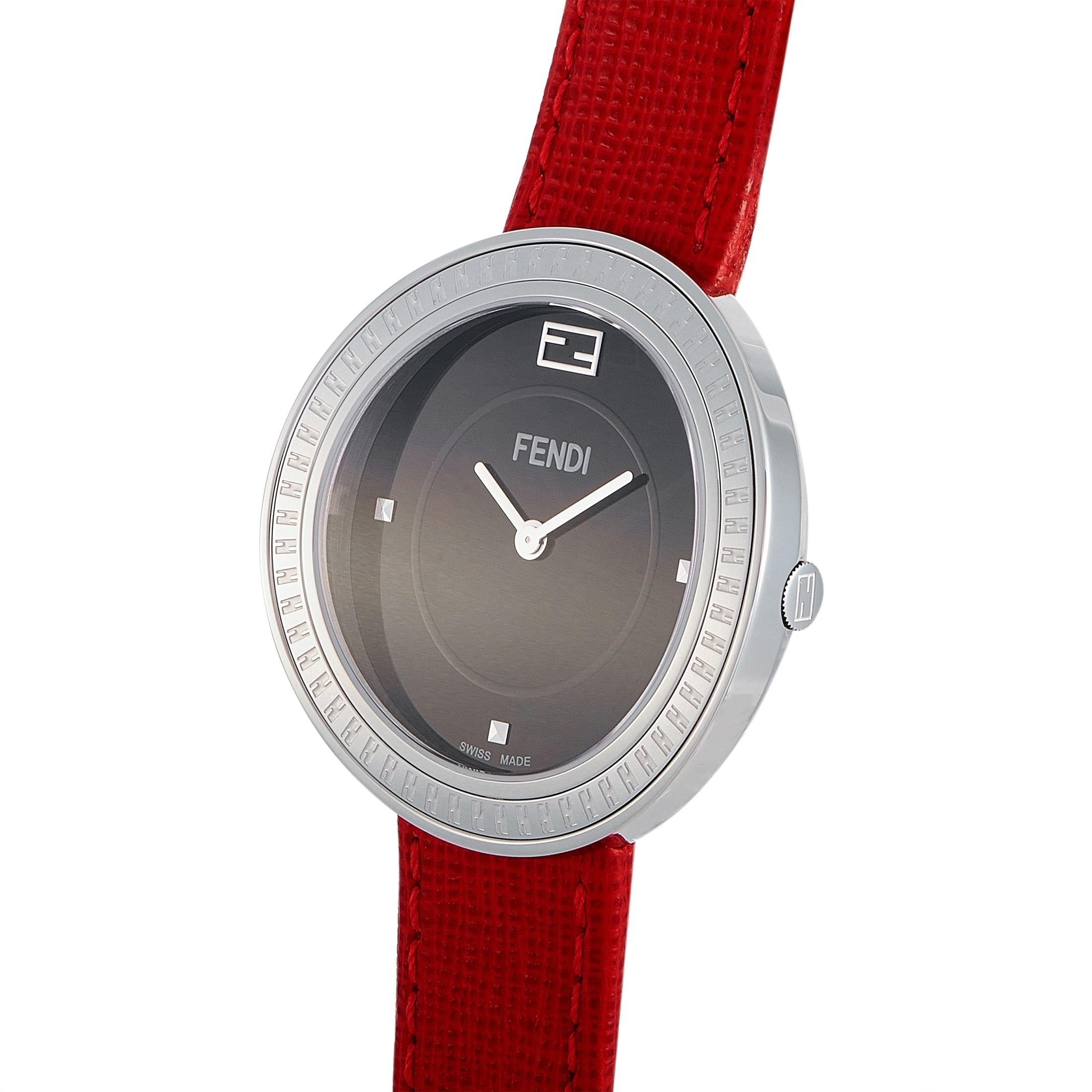 The Fendi My Way watch, reference number F354031073, boasts a 36 mm stainless steel case that is presented on a red leather strap, secured on the wrist with a tang buckle. This model is powered by a quartz movement and indicates hours and minutes on