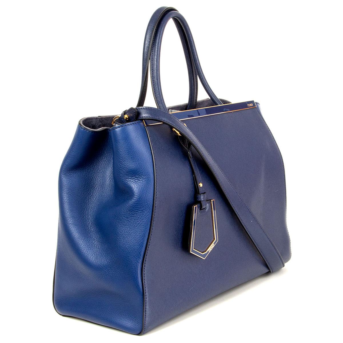 100% authentic Fendi 2Jours Medium tote shoulder bag in blue calfskin leather (100%) with shoulder strap. Closes with one snap button at top and has two interior-compartments with one zipper pocket in the middle and two flat pockets against the