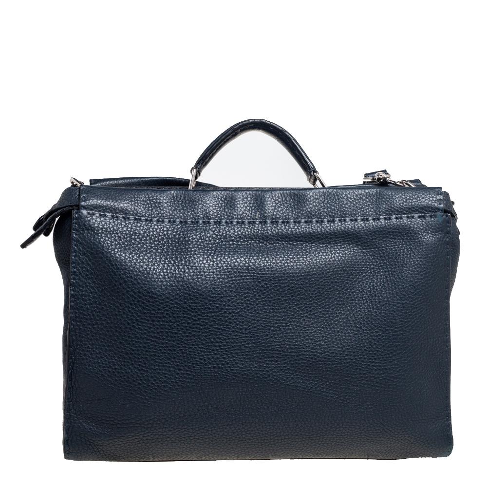 This exquisite Peekaboo from Fendi is highly coveted and sways us with its shape, design, and beauty. This version comes meticulously crafted from leather and is designed with a top handle for you to swing it. The navy blue creation has a spacious