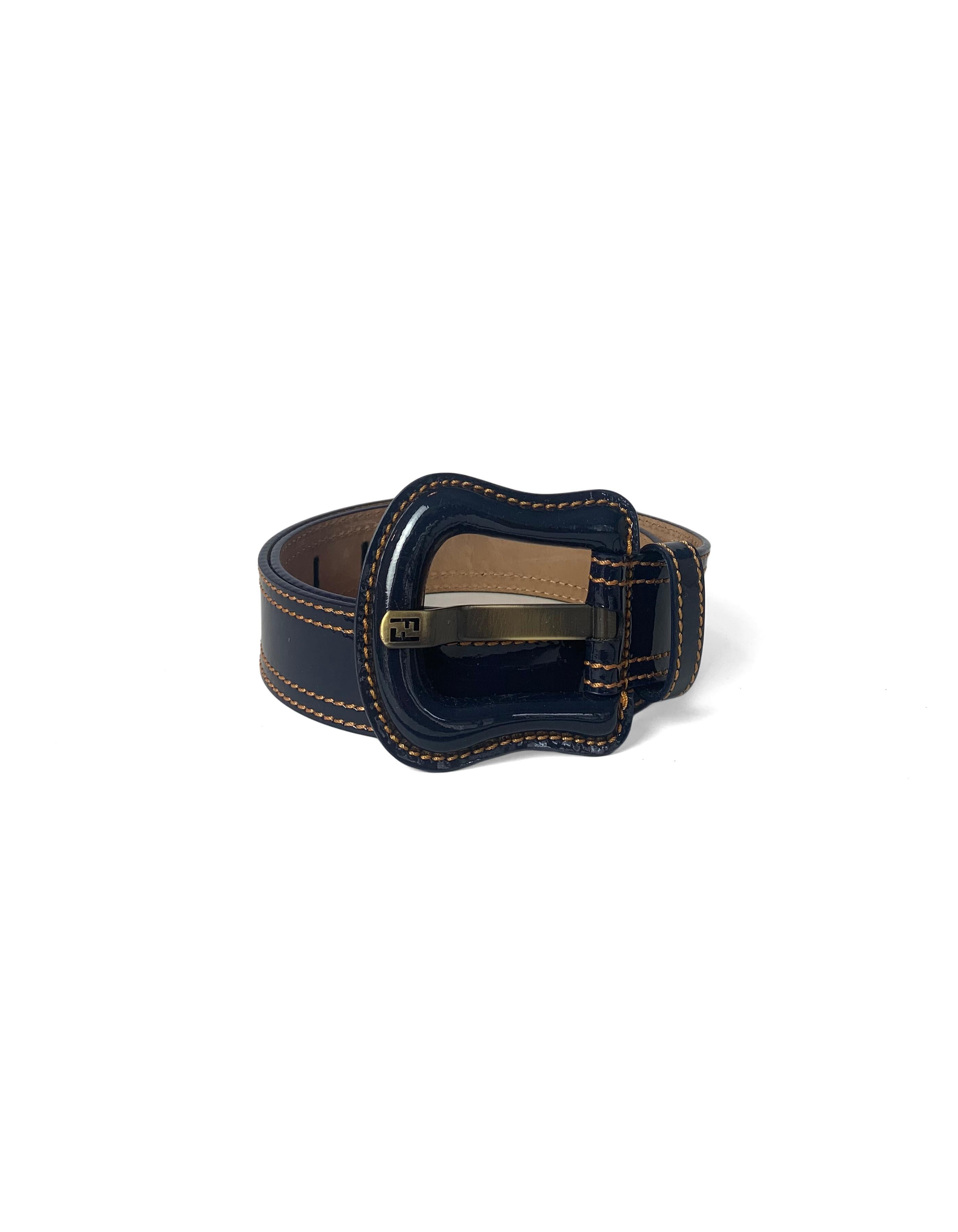 Fendi Navy Blue Patent Leather Buckle Belt sz 75

Made In: Italy
Color: Blue with orange contrast stitching
Hardware: Antiqued goldtone
Materials: Patent leather
Lining: Smooth leather
Closure/Opening: Adjustable buckle
Overall Condition: Excellent