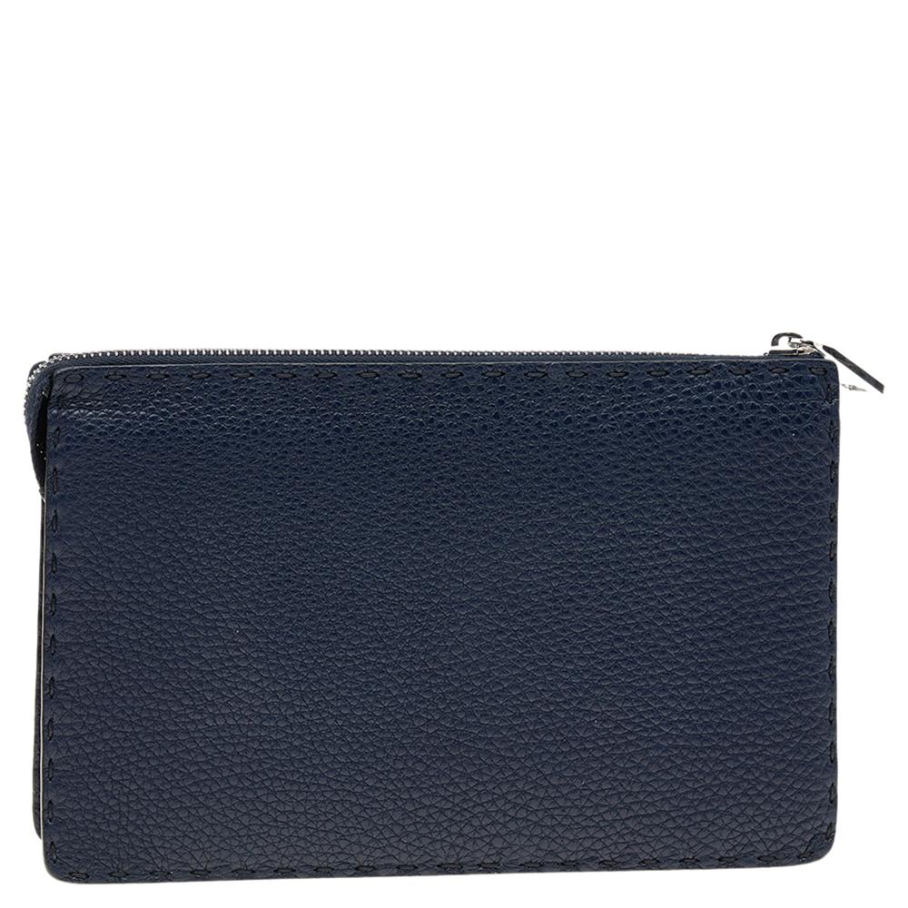 This clutch from Fendi is just right as a stylish accessory. It is crafted from blue and white leather and is designed with the signature bug eyes on the front. It has multiple compartments, silver-tone hardware, and a front hand slot for effortless
