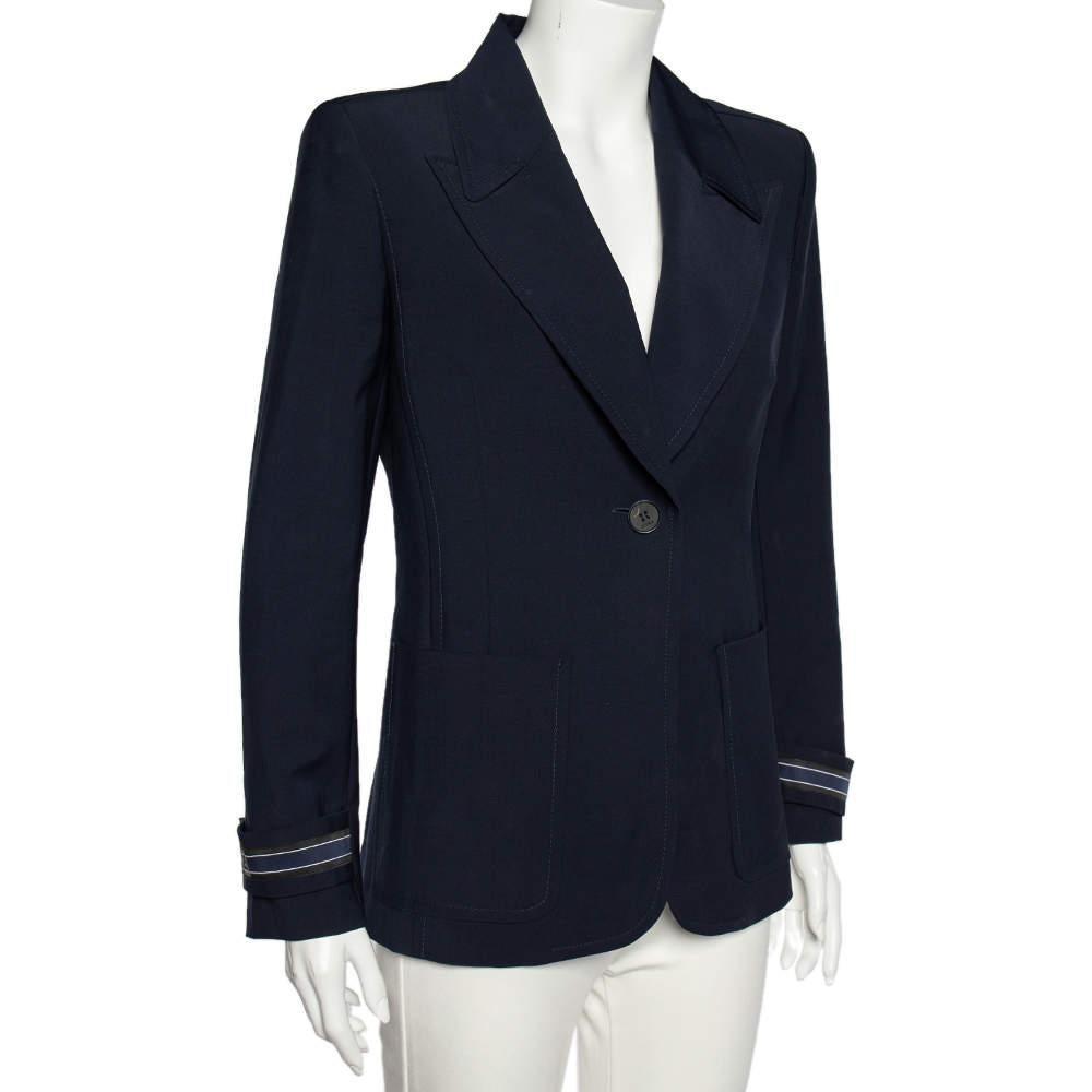 Finished with a trendy design, this blazer from Fendi emits a modern style statement. This piece is skillfully crafted using navy-blue wool with striped cuff details, two external pockets, and a buttoned closure on the front. This tailored blazer