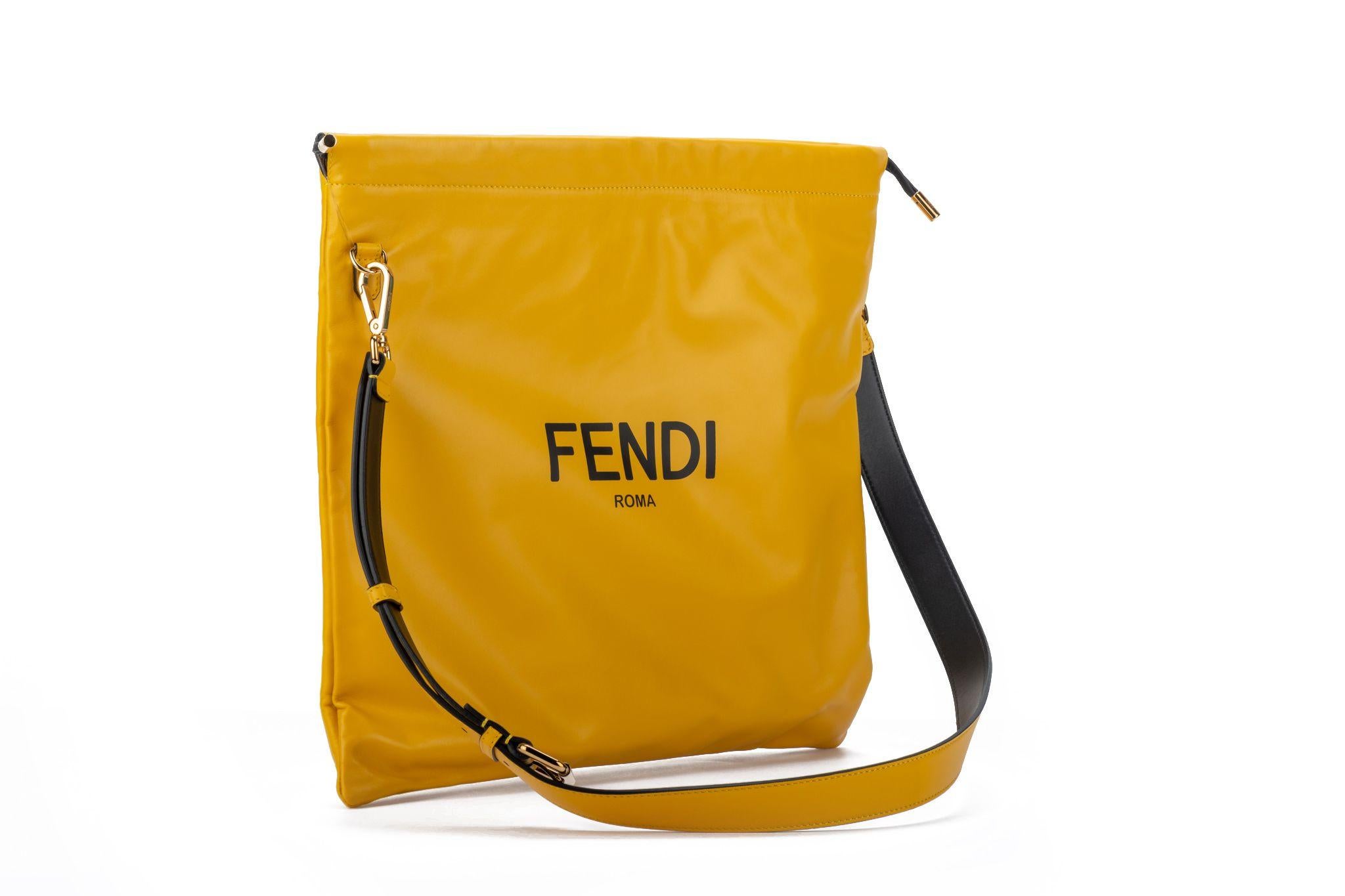Fendi new large yellow lambskin cross body bag. 20” adjustable shoulder strap. Black details and hardware in gold . Booklet and original dustcover.
