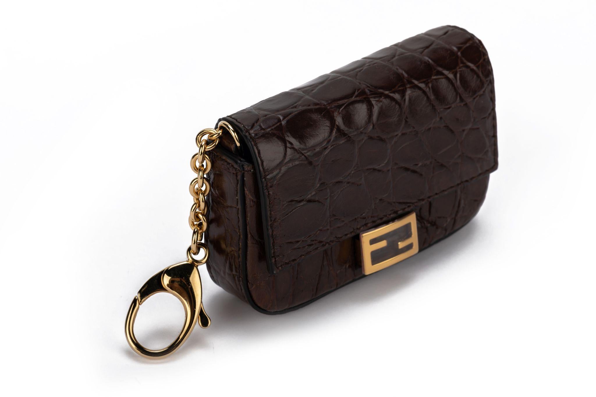 Fendi brown cayman nano baguette with gold tone hardware. 19,5 inches detachable shoulder strap. Can be worn as a charms also or a belt bag. Cites declaration included. Box, booklet and original dustcover.