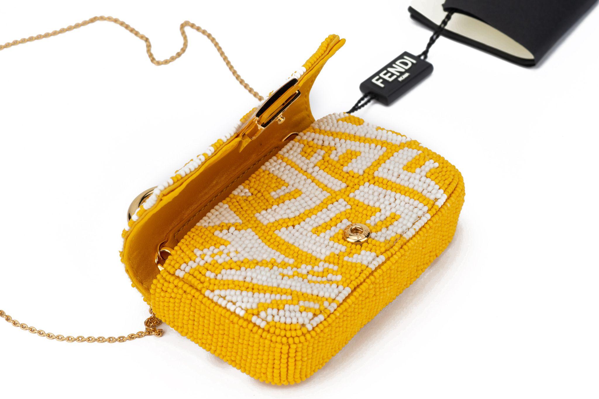 Fendi white and yellow seabeds vertigo logo nano baguette, gold tone hardware. 
Detachable shoulder strap measures 22