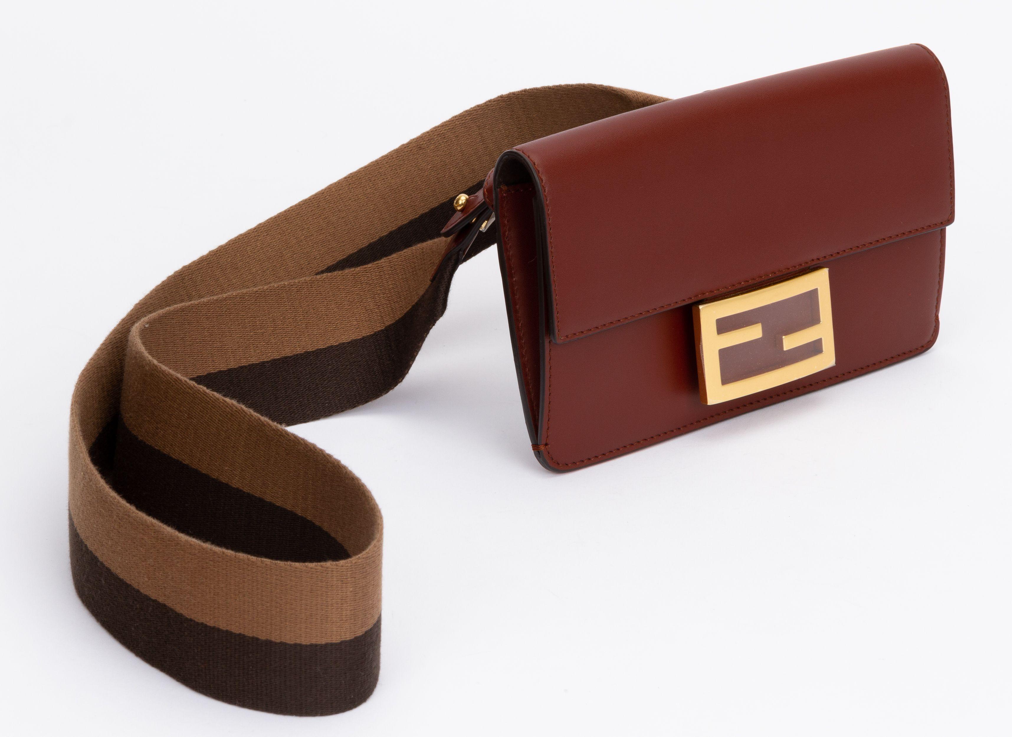 Fendi brown leather flat baguette bag. The bag closes with a FF snap on front and on the back a shoulder strap (drop 19