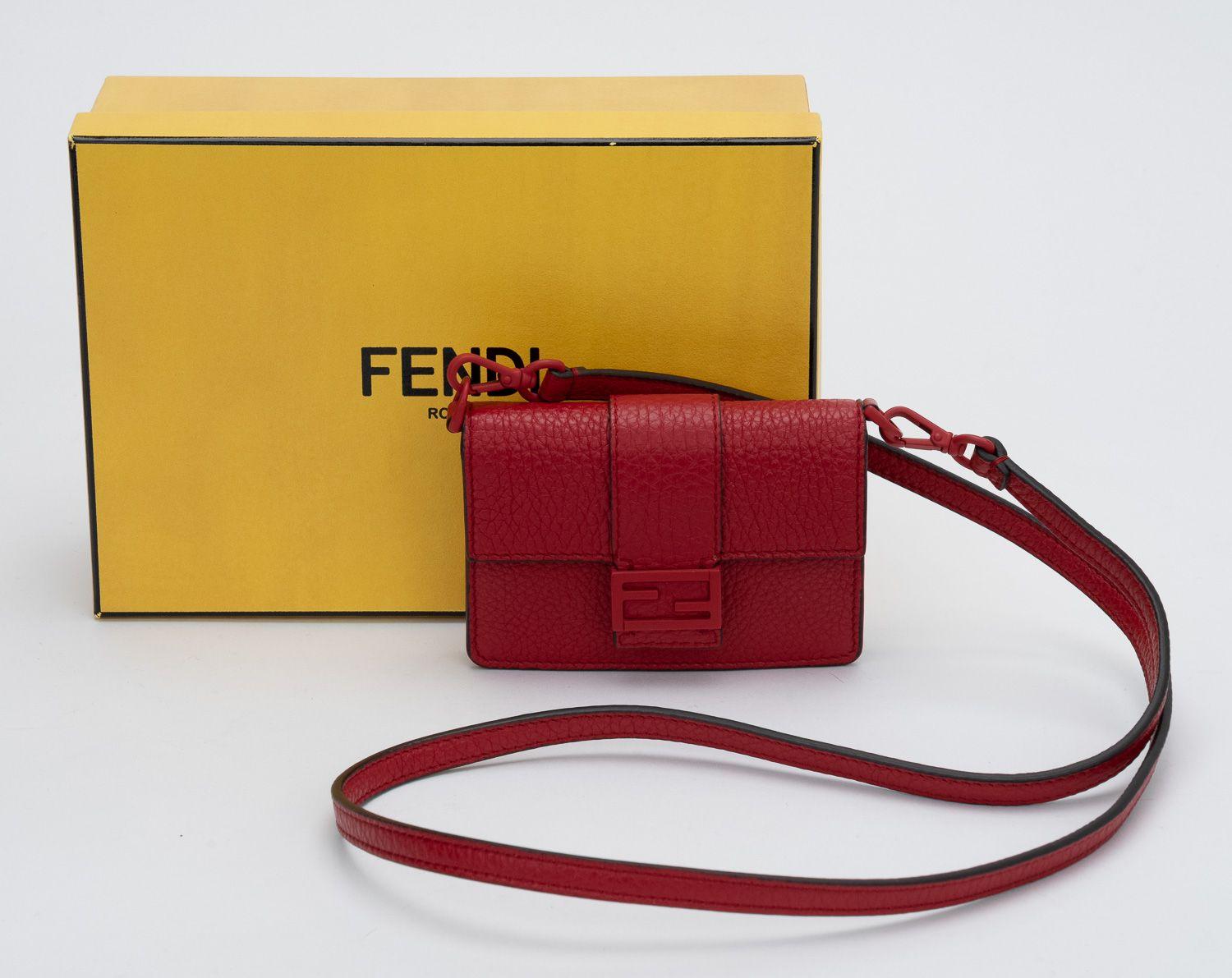 Fendi micro baguette in red pebbled leather. Brand new in unworn condition. Fits credit cards and keys .Shoulder drop 18.5