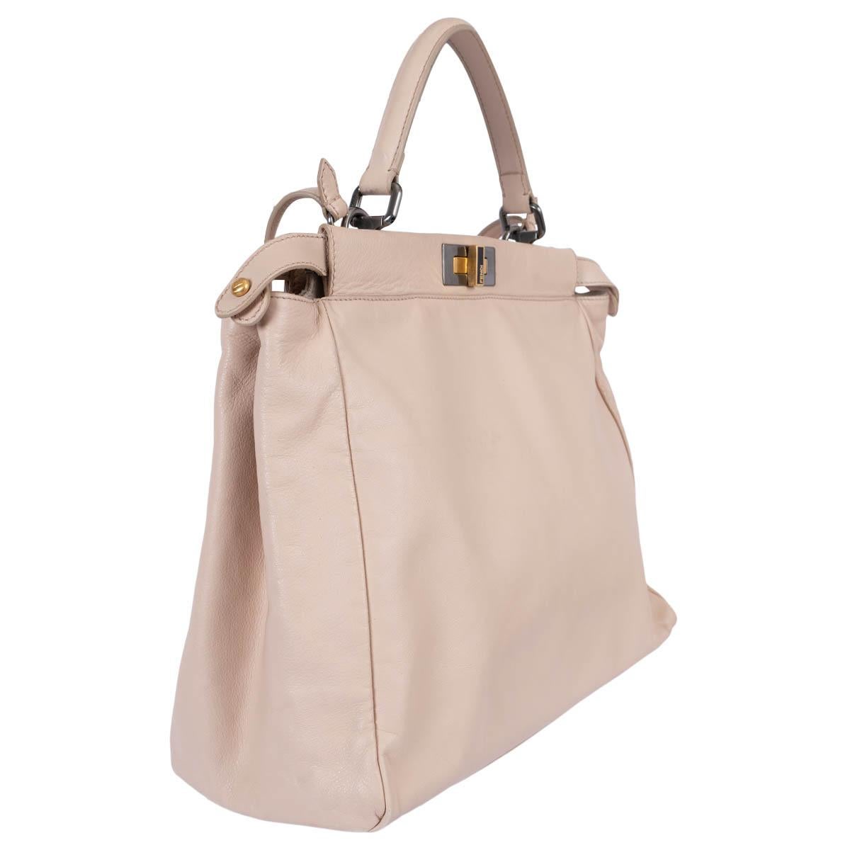 100% authentic Fendi Peekaboo Large shoulder bag in nude leather. Featuring gold-tone and ruthenuim hardware. Opens with turn-lock to a dual-compartment interior with one zipper pocket in the middle. Lined in off-white suede. Comes with a detachable