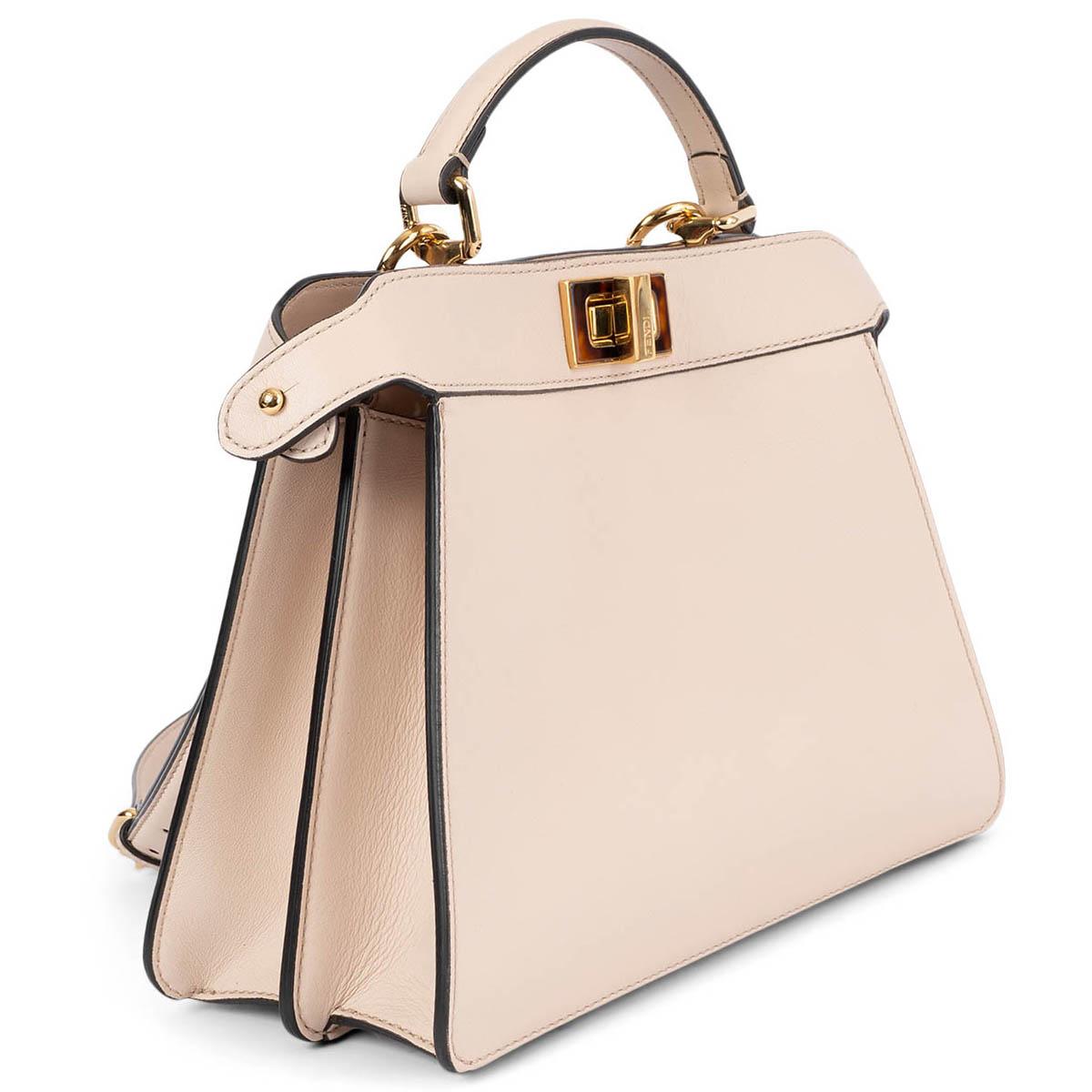100% authentic Fendi Peekaboo ISeeU small bag made of nude leather and embellished with the classic twist lock on both sides. Featuring soft nappa leather lining, two compartments separated by a stiff partition, inner flat pocket, bar and fastening