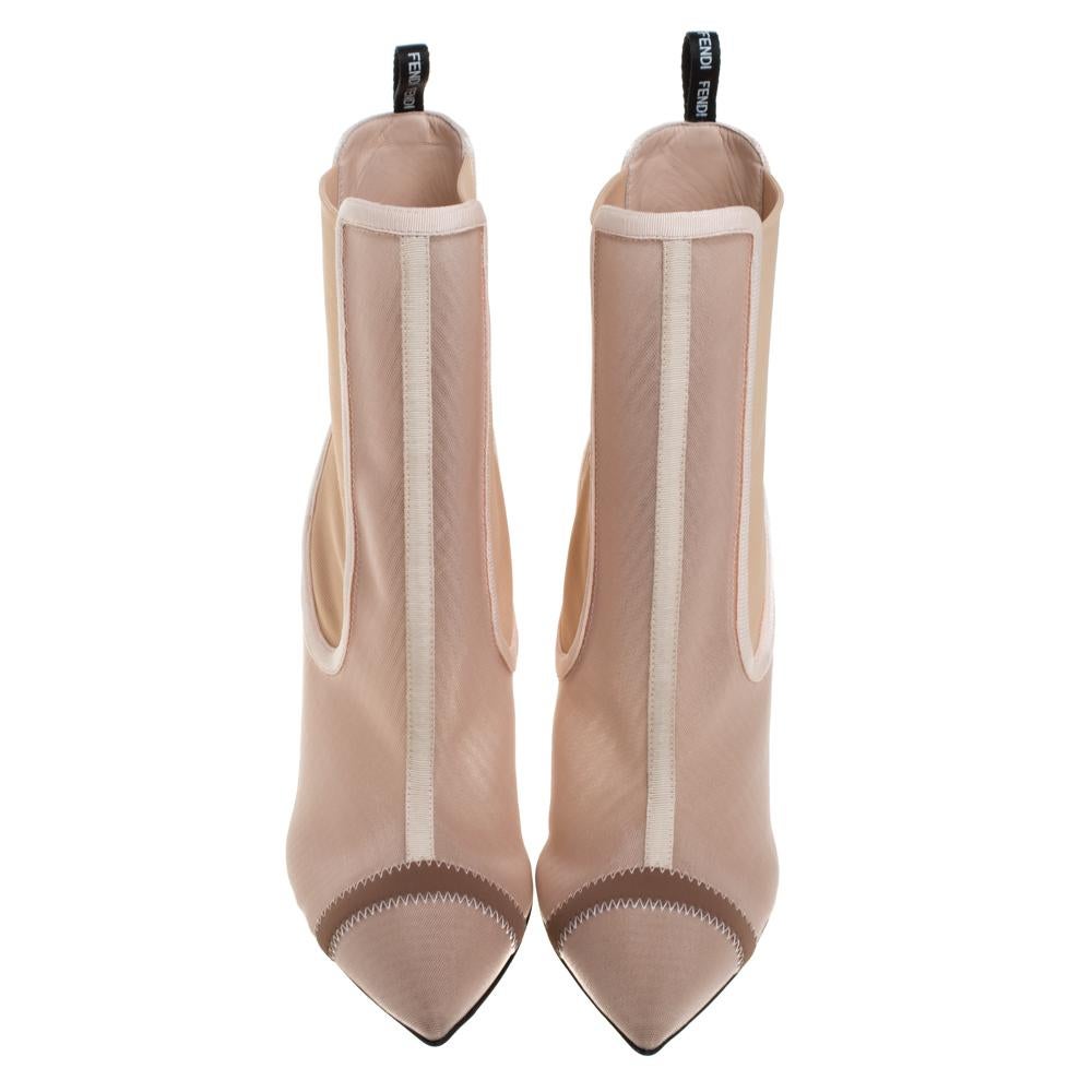 Crafted out of nude pink mesh and fabric, these Fendi ankle-length boots are charming enough for you to own them. They feature pointed toes and the 'FENDI' label on the counters. They come endowed with comfortable leather-lined insoles and stand