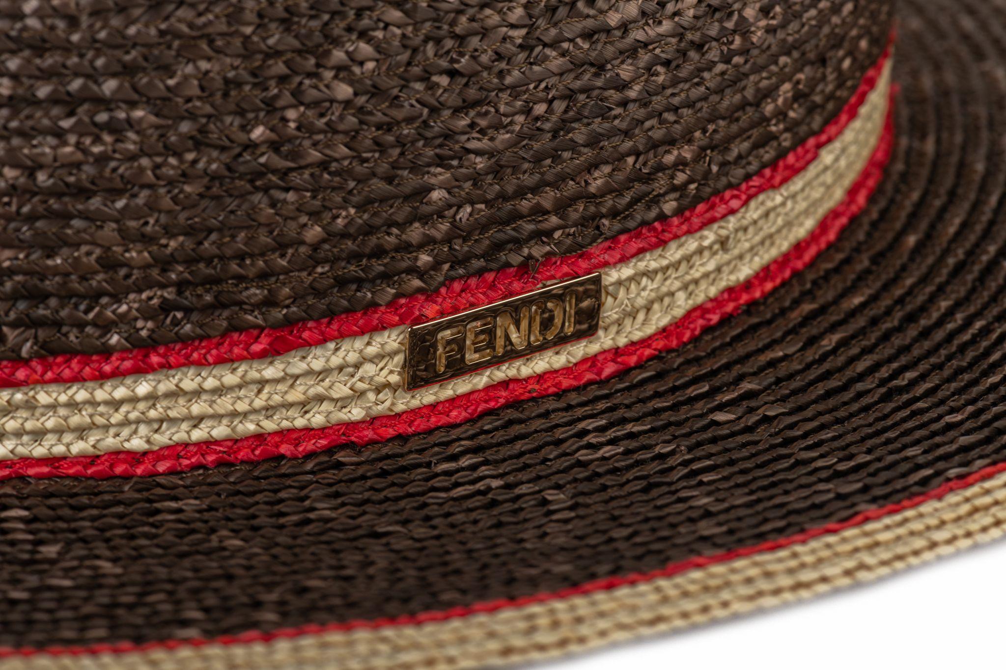 Fendi new with tag brown straw hat with red and beige stripe. Size M, 59 cm. Unworn condition. Comes with original tag cover .