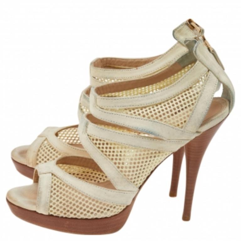 Create a stunning silhouette with this pair of sandals from Fendi. Crafted from suede and mesh, the sandals are styled in a caged layout, secured with zippers, and elevated on 12.5 cm heels. The leather insoles carry the brand's well-known label.