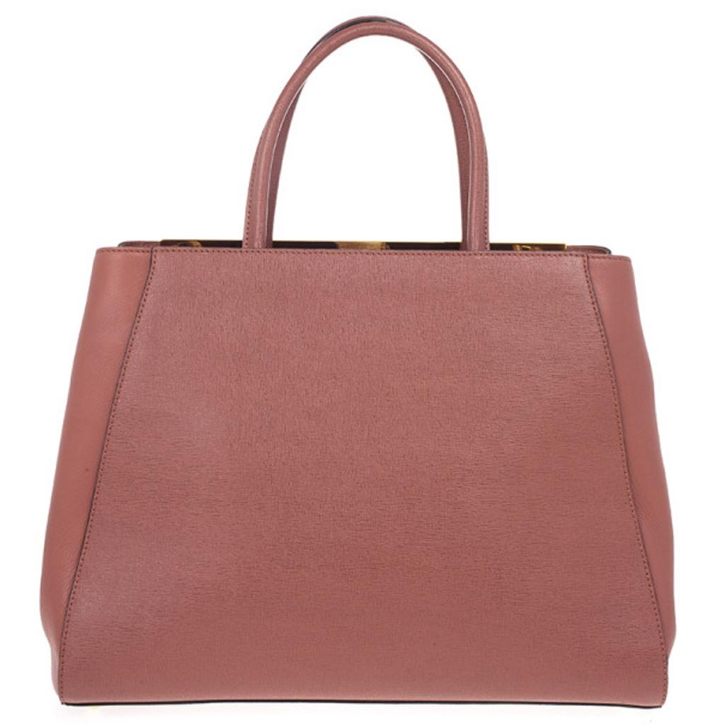 Seen on the arms of our beloved Sarah Jessica Parker and Jessica Biel, the 2Jours tote bag by Fendi. This version is crafted from textured leather. It is detailed with Logo-detailed enamel bar trim, a snap top closure, leather handles and a shoulder