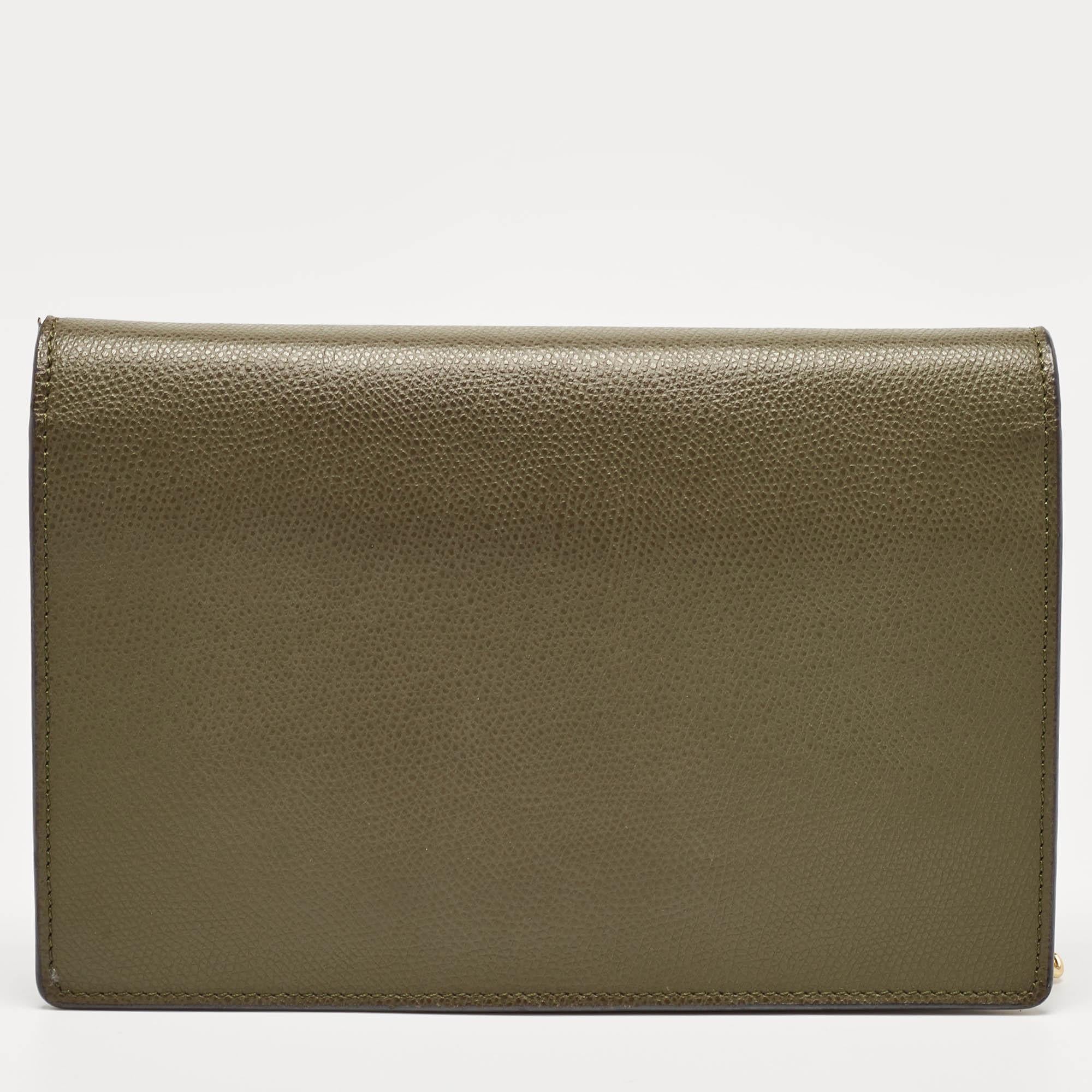 This Fendi Wallet On Chain has been beautifully crafted using olive green leather. The flap carries the F logo in gold-tone metal, and it secures a lined interior sized to dutifully hold your essentials. The bag is complete with a shoulder