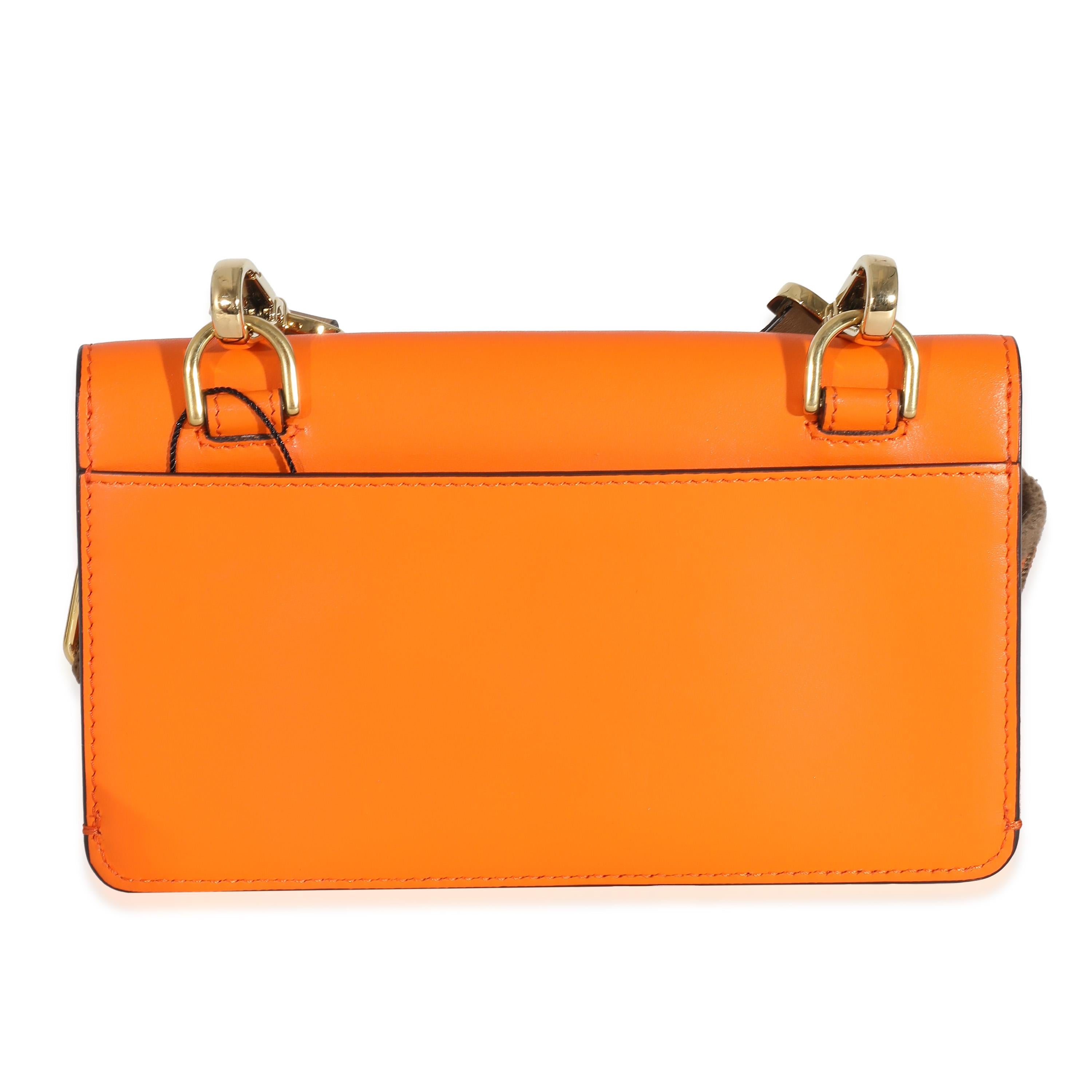 Listing Title: Fendi Orange Calfskin Mini Flat Baguette with Brown 'Strap You' Strap
SKU: 114508
MSRP: 2170.00 USD
Condition: Pre-owned 
Condition Description: A Fendi classic. The Baguette bag is synonymous with the early 2000s and made a name for