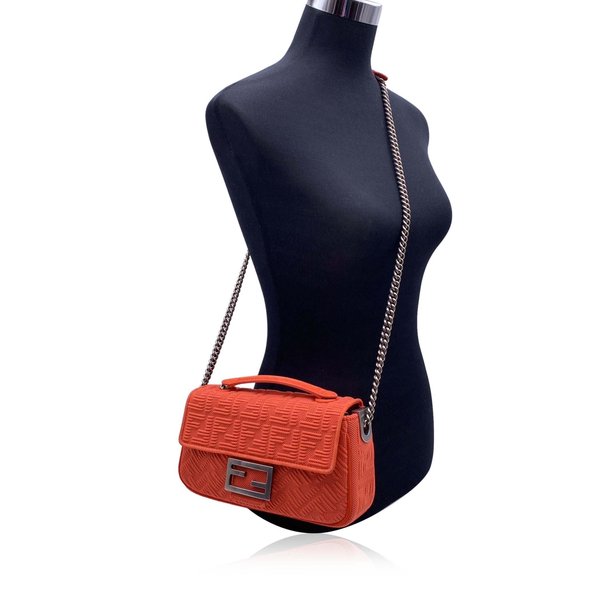 This beautiful Bag will come with a Certificate of Authenticity provided by Entrupy, The certificate will be provided at no further cost. Gorgeous FENDI 'Baguette Chain' bag in orange technical mesh canvas with embossed FF monogram pattern. A simple