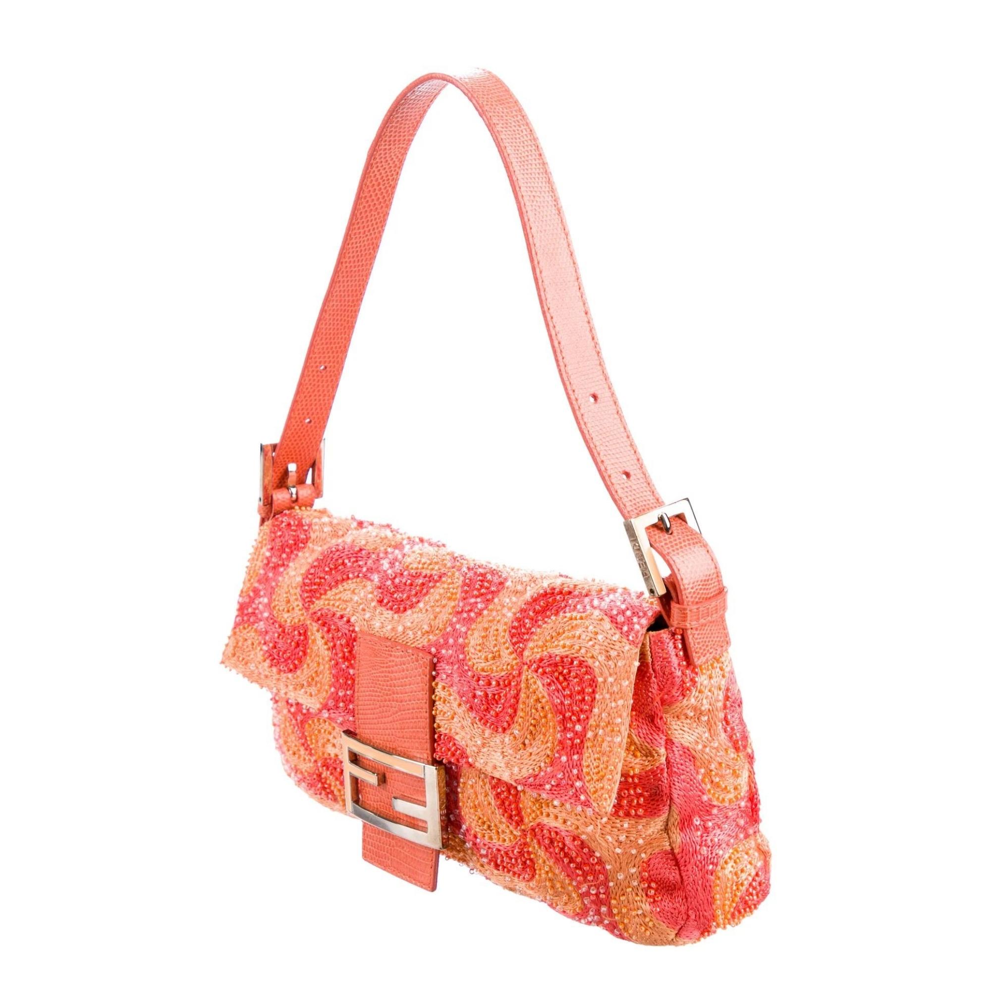 This bag features silver-tone tone hardware, single flat shoulder strap, orange lizard trim, marigold and multicolor embroidered exterior with beads, lime satin lining, single interior zip pocket and magnetic snap closure at front flap featuring FF