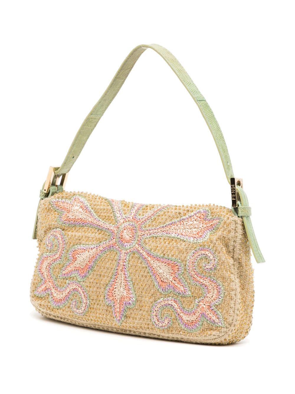 This Beige Paisley Embroidered Beaded Baguette Bag is the perfect accessory for any fashionista. Made from high-quality materials, this bag features an exotic leather trim and strap, a crystal embellished FF logo, and gold tone hardware. Satin